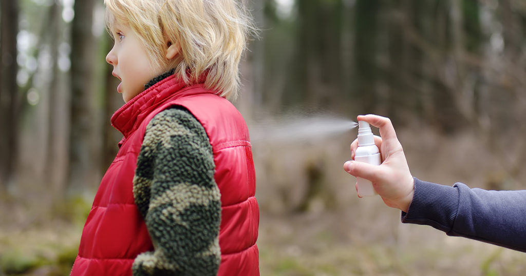 anti-tick spray on a kid, image