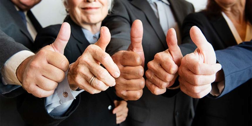 business people giving thumbs up