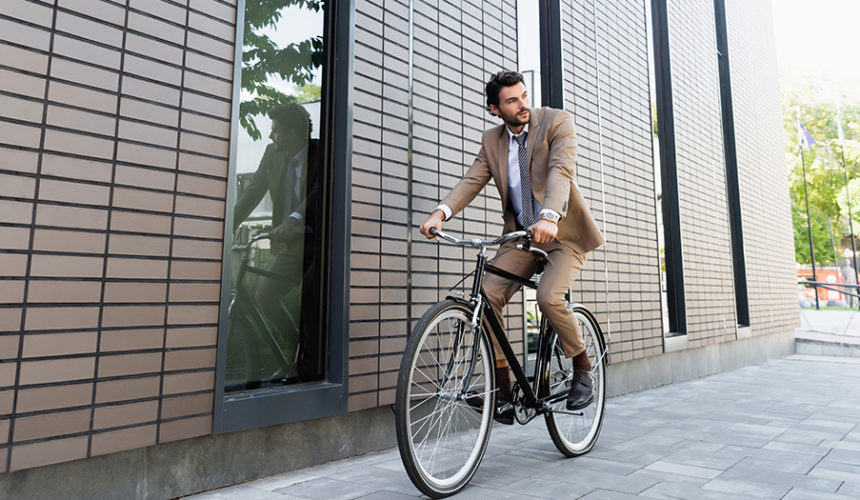 Sport for better stress management businessman riding a bicycle