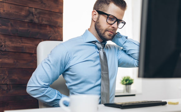 man with back pain at the office