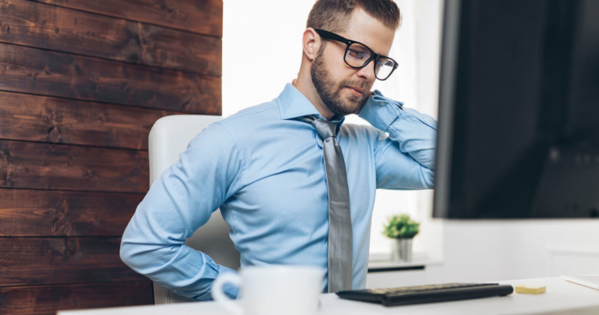 man with back pain at the office