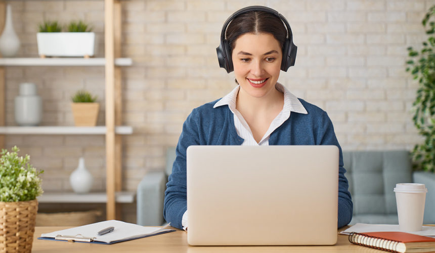 Home Office young woman working from home with laptop and headset