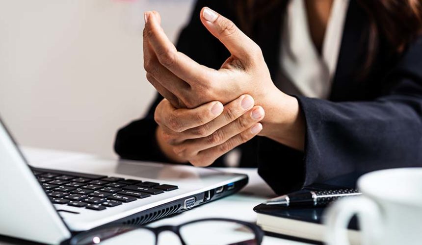 Musculoskeletal disorders and work with computer screens person with wrist pain works on a computer